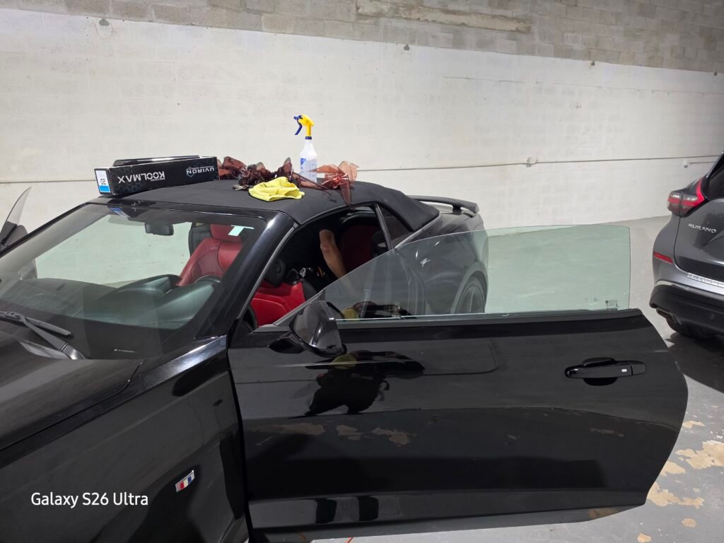 Side view of the Camaro during installation, with tools and film on the roof